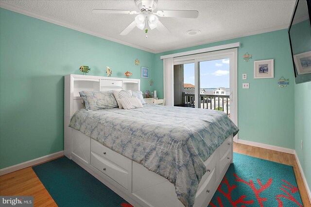 11603 Seaward Rd Unit 6, Ocean City, MD 21842 - bedroom with access to outside, a textured ceiling, wood finished floors, ornamental molding, and a ceiling fan