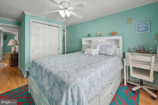11603 Seaward Rd Unit 6, Ocean City, MD 21842 - bedroom with wood finished floors, ornamental molding, a closet, ceiling fan, and a textured ceiling
