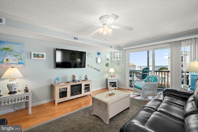 11603 Seaward Rd Unit 6, Ocean City, MD 21842 - living area featuring wood finished floors, a textured ceiling, ceiling fan, and ornamental molding