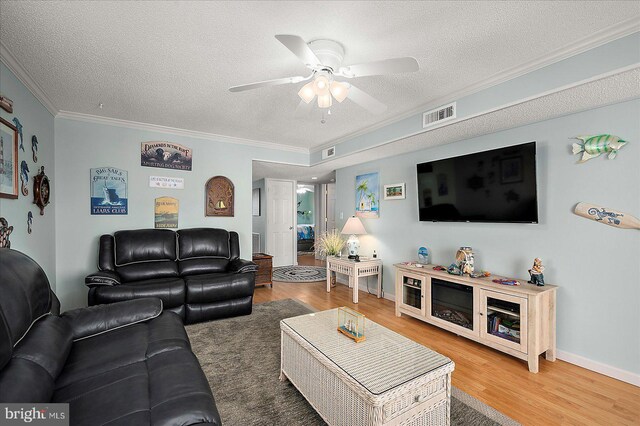 11603 Seaward Rd Unit 6, Ocean City, MD 21842 - living room featuring a textured ceiling, ornamental molding, a ceiling fan, and wood finished floors