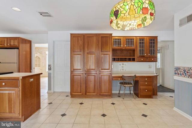 3 Lisa Ct, Elkton, MD 21921 - kitchen with freestanding refrigerator, built in study area, brown cabinets, and light countertops