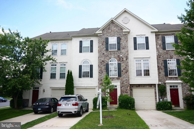 10677 Hillingdon Rd, Woodstock, MD 21163 - townhome / multi-family property featuring driveway, stone siding, an attached garage, and a front lawn