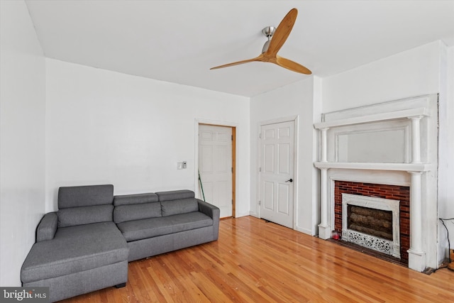 3737 N 18th St, Philadelphia, PA 19140 - living area featuring wood finished floors, a ceiling fan, and a fireplace