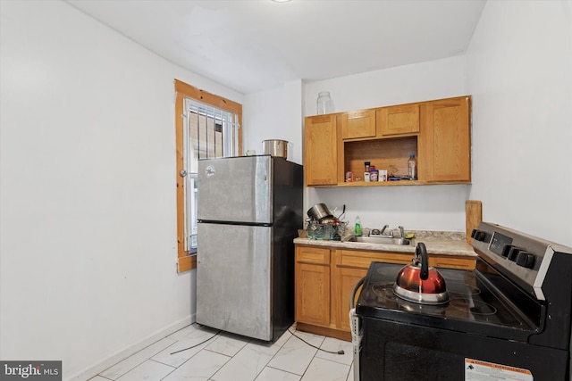 3737 N 18th St, Philadelphia, PA 19140 - kitchen with stainless steel appliances, a sink, light marble finish floors, light countertops, and baseboards