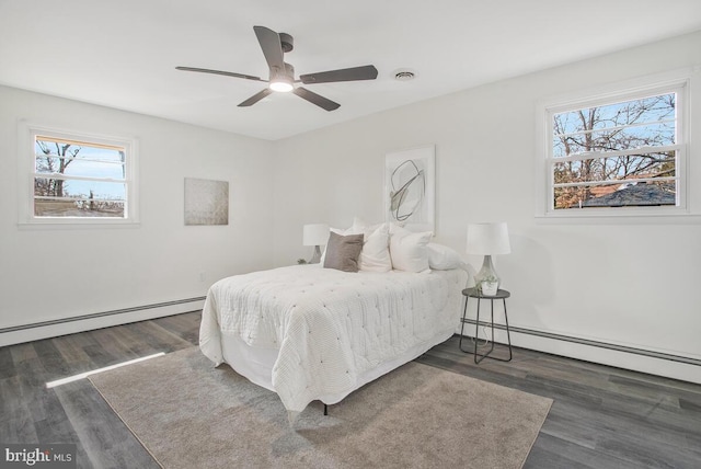 5917 Linthicum Ln, Linthicum Heights, MD 21090 - bedroom featuring a baseboard heating unit, multiple windows, and wood finished floors