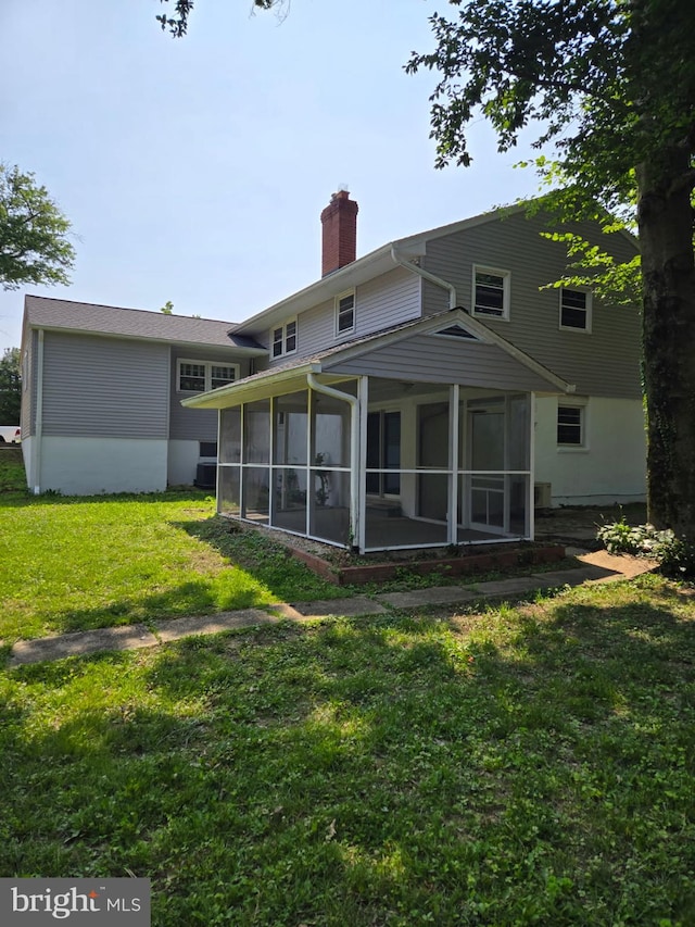 5917 Linthicum Ln, Linthicum Heights, MD 21090 - rear view of property with a chimney, a sunroom, and a yard