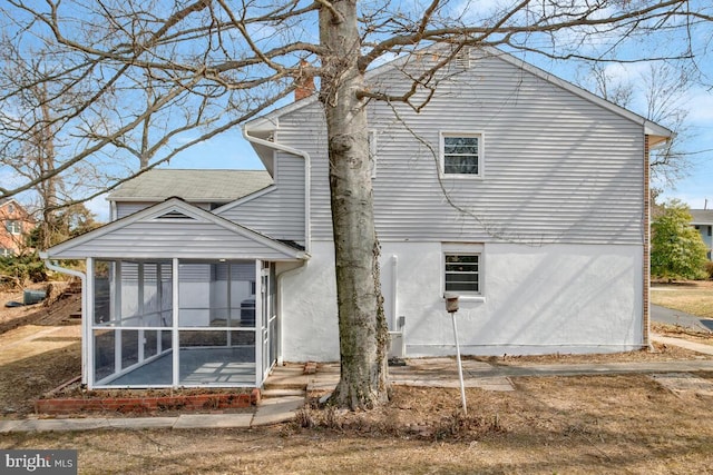 5917 Linthicum Ln, Linthicum Heights, MD 21090 - back of house featuring a sunroom and a chimney