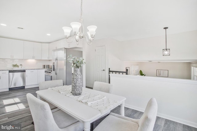 5917 Linthicum Ln, Linthicum Heights, MD 21090 - dining area featuring wood finished floors, a chandelier, and recessed lighting