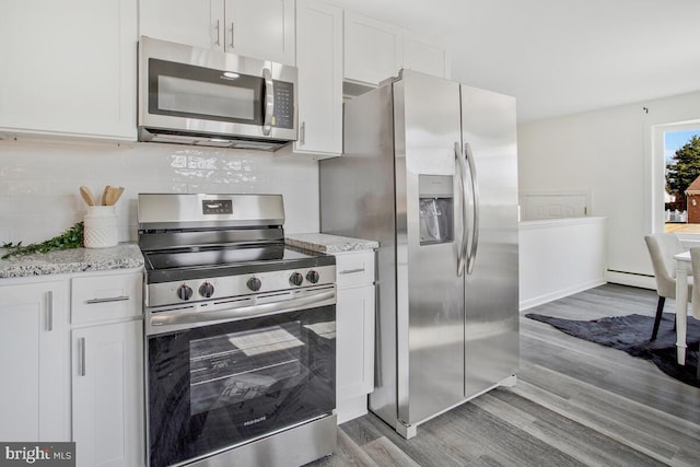 5917 Linthicum Ln, Linthicum Heights, MD 21090 - kitchen with appliances with stainless steel finishes, baseboard heating, wood finished floors, and white cabinets