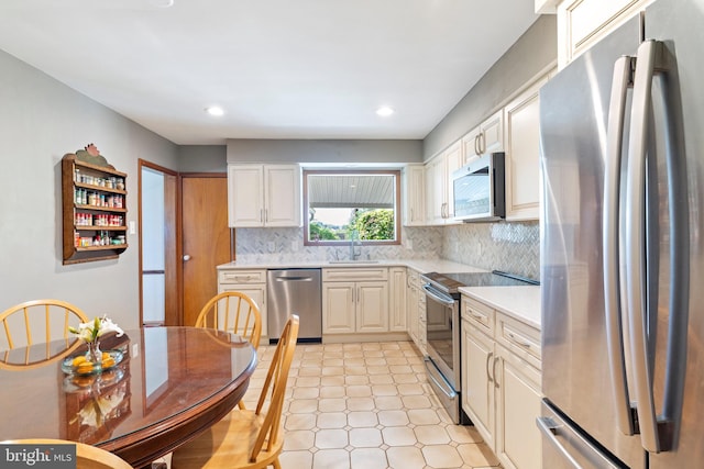 1540 Davidson Rd, Abington, PA 19001 - kitchen featuring appliances with stainless steel finishes, light countertops, backsplash, recessed lighting, and white cabinetry