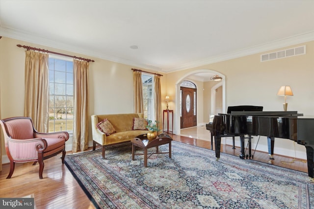 2573 Muirfield Way, Lansdale, PA 19446 - living area featuring arched walkways, wood finished floors, and ornamental molding