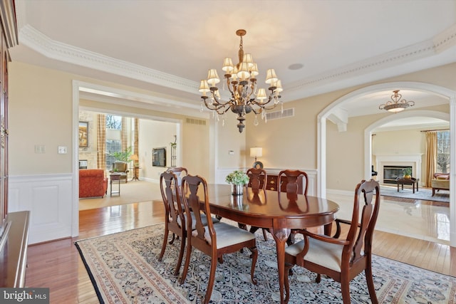 2573 Muirfield Way, Lansdale, PA 19446 - dining room with arched walkways, a chandelier, a wainscoted wall, light wood-type flooring, and ornamental molding