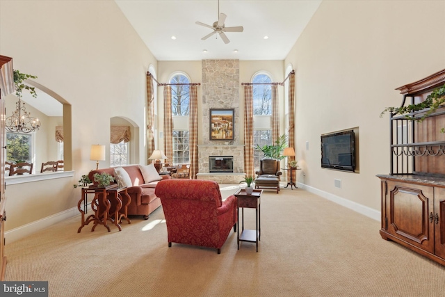 2573 Muirfield Way, Lansdale, PA 19446 - living area featuring healthy amount of natural light, a stone fireplace, a high ceiling, light carpet, and ceiling fan