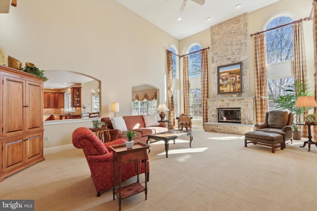 2573 Muirfield Way, Lansdale, PA 19446 - living room featuring a towering ceiling, light carpet, healthy amount of natural light, ceiling fan, and arched walkways