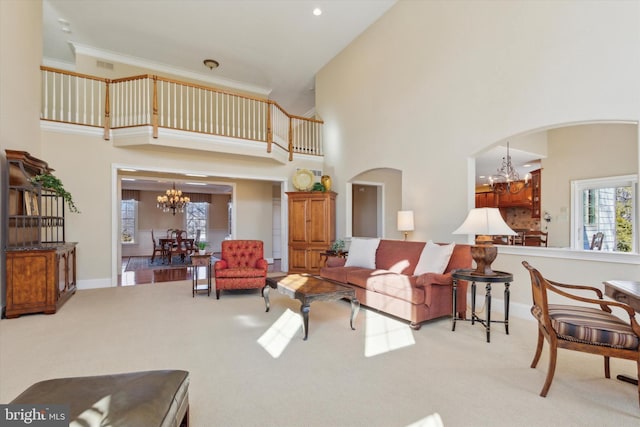 2573 Muirfield Way, Lansdale, PA 19446 - living room with a chandelier, arched walkways, a towering ceiling, carpet floors, and recessed lighting