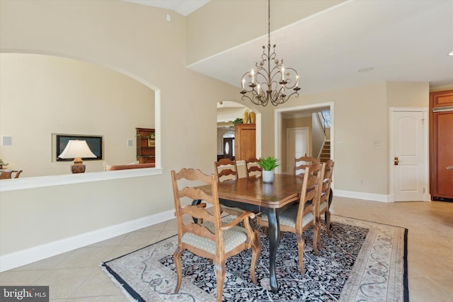 2573 Muirfield Way, Lansdale, PA 19446 - dining area featuring arched walkways, light tile patterned floors, stairs, and a chandelier