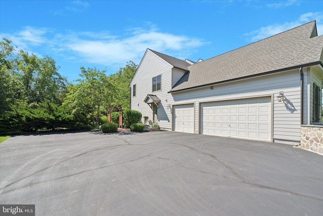 2573 Muirfield Way, Lansdale, PA 19446 - view of side of home featuring an attached garage, driveway, and a shingled roof