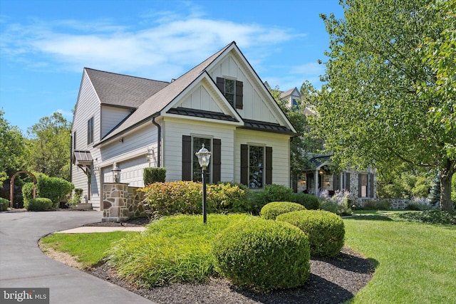 2573 Muirfield Way, Lansdale, PA 19446 - view of front of home featuring driveway, a standing seam roof, a front yard, board and batten siding, and a metal roof