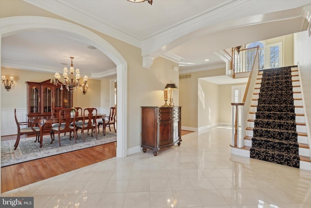 2573 Muirfield Way, Lansdale, PA 19446 - foyer entrance featuring ornamental molding, stairway, arched walkways, a chandelier, and light tile patterned flooring
