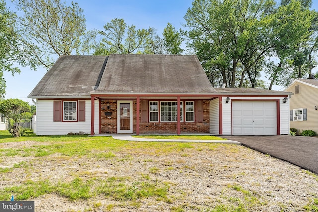 15 Excell Ln, Willingboro, NJ 08046 - view of front facade featuring an attached garage, asphalt driveway, covered porch, and brick siding