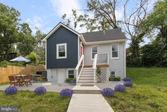 5021 A St SE, Washington, DC 20019 - view of front of property with brick siding, a patio, and roof with shingles