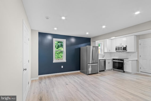 5021 A St SE, Washington, DC 20019 - kitchen featuring appliances with stainless steel finishes, white cabinets, light countertops, light wood-type flooring, and recessed lighting