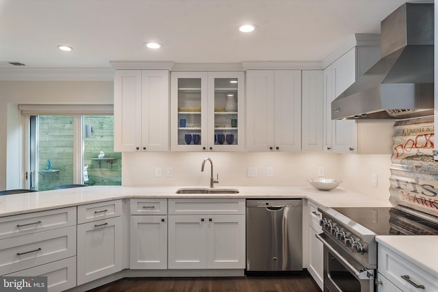 16 Spa Creek Lndg, Annapolis, MD 21403 - kitchen featuring wall chimney range hood, stainless steel appliances, ornamental molding, white cabinets, and glass insert cabinets