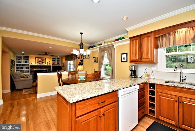 403 Grenoble Dr, Sellersville, PA 18960 - kitchen with white dishwasher, a peninsula, a fireplace, light stone counters, and light wood-style flooring