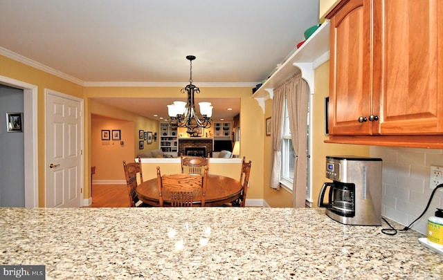 403 Grenoble Dr, Sellersville, PA 18960 - dining area with ornamental molding, a chandelier, and a fireplace
