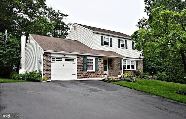403 Grenoble Dr, Sellersville, PA 18960 - view of front facade with brick siding, a garage, asphalt driveway, a chimney, and a front yard
