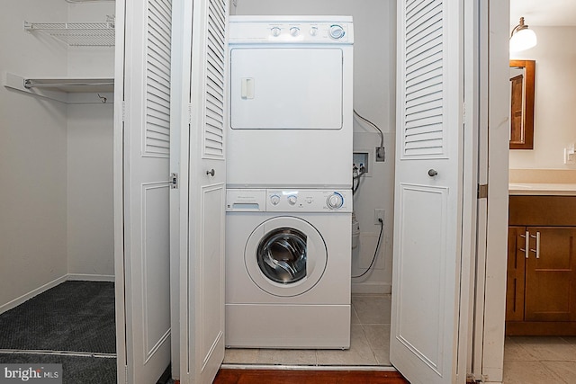 1919 Chestnut St Unit 1722, Philadelphia, PA 19103 - laundry room with stacked washing machine and dryer and baseboards