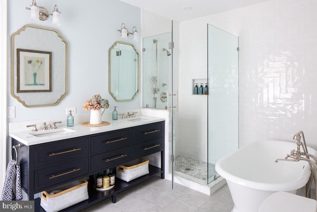 673 Ardmore Ave, Ardmore, PA 19003 - bathroom featuring a soaking tub, double vanity, a stall shower, and tile patterned flooring