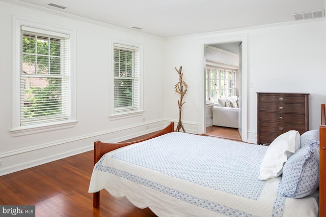 673 Ardmore Ave, Ardmore, PA 19003 - bedroom with wood finished floors, multiple windows, and ornamental molding