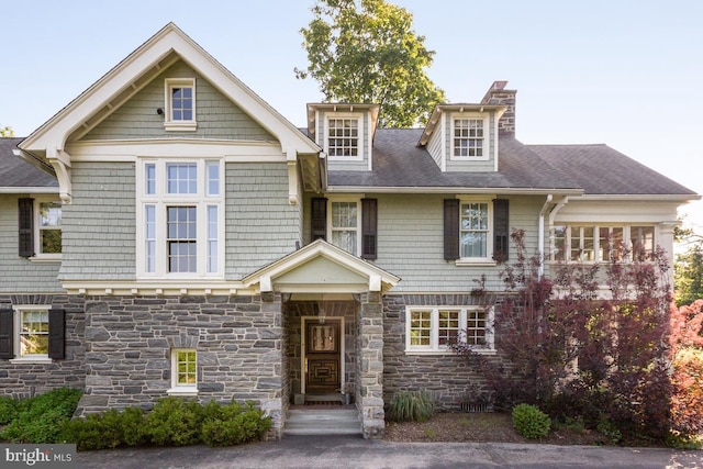673 Ardmore Ave, Ardmore, PA 19003 - view of front of home with stone siding, a chimney, and a shingled roof