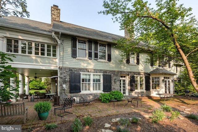 673 Ardmore Ave, Ardmore, PA 19003 - rear view of house with a chimney, stone siding, a ceiling fan, and a patio area