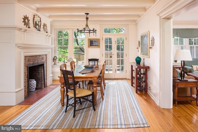 673 Ardmore Ave, Ardmore, PA 19003 - dining room featuring french doors, light wood-type flooring, beamed ceiling, a chandelier, and a decorative wall