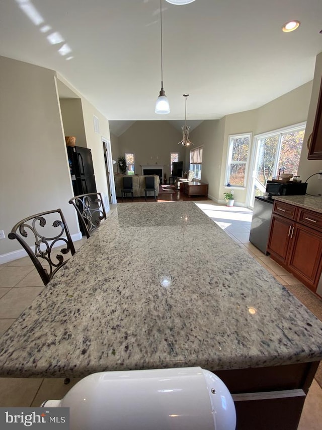 5 Sameera Ct, New Egypt, NJ 08533 - kitchen featuring light tile patterned floors, light stone counters, open floor plan, pendant lighting, and lofted ceiling