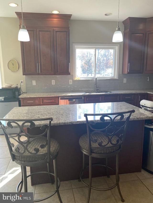 5 Sameera Ct, New Egypt, NJ 08533 - kitchen with stainless steel dishwasher, decorative backsplash, a breakfast bar, light stone counters, and recessed lighting