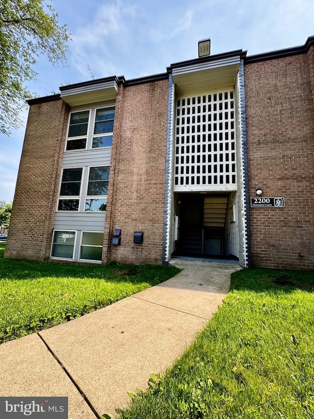 2200 Greenery Ln Unit 201-, Silver Spring, MD 20906 - view of front of home featuring brick siding, a front yard, and crawl space