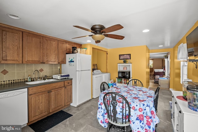 1621 E Hewson St, Philadelphia, PA 19125 - kitchen with white appliances, washer and clothes dryer, ceiling fan, brown cabinets, and backsplash