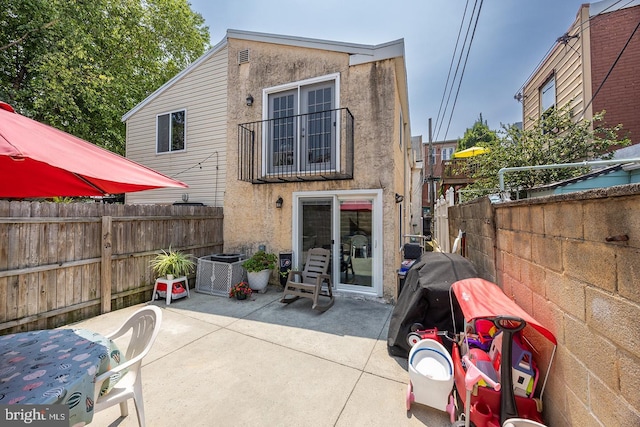1621 E Hewson St, Philadelphia, PA 19125 - rear view of property with a patio, stucco siding, and a fenced backyard