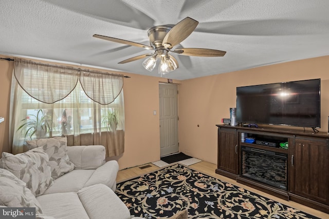 1621 E Hewson St, Philadelphia, PA 19125 - living area featuring a ceiling fan, light wood-style floors, and a textured ceiling