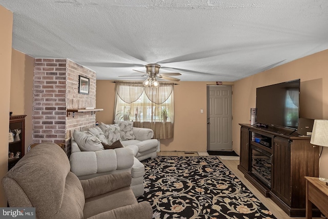 1621 E Hewson St, Philadelphia, PA 19125 - living area featuring a ceiling fan, a fireplace, light wood-style floors, and a textured ceiling
