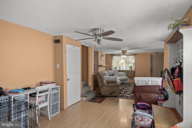 1621 E Hewson St, Philadelphia, PA 19125 - living room featuring a ceiling fan, light wood-style floors, a textured ceiling, and stairs