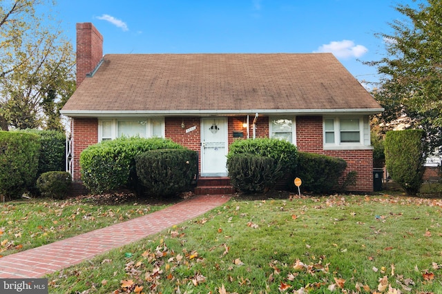 6602 8th Ave, Hyattsville, MD 20783 - view of front of house featuring brick siding, a front lawn, a chimney, and roof with shingles