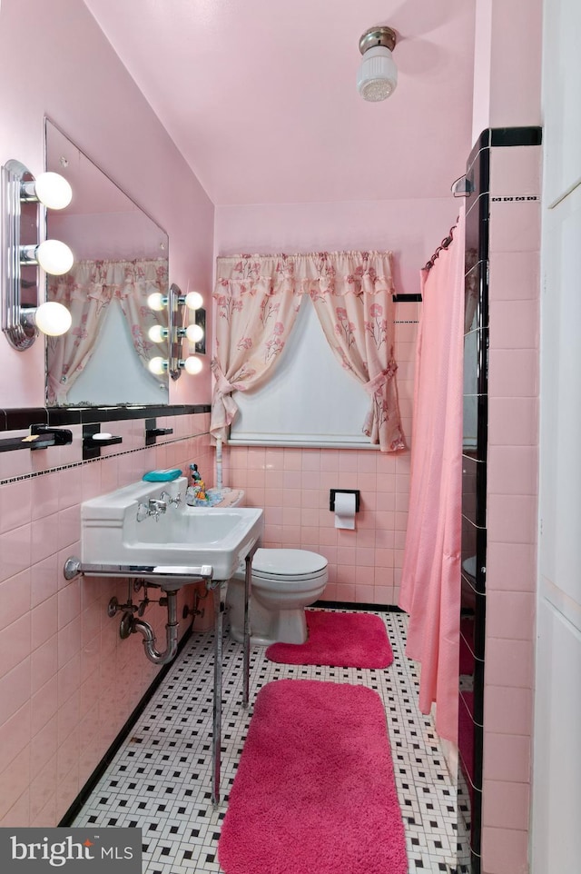 6602 8th Ave, Hyattsville, MD 20783 - full bathroom featuring a shower with shower curtain, a wainscoted wall, tile walls, and tile patterned flooring