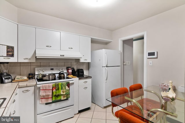 6602 8th Ave, Hyattsville, MD 20783 - kitchen featuring white appliances, under cabinet range hood, decorative backsplash, and white cabinetry