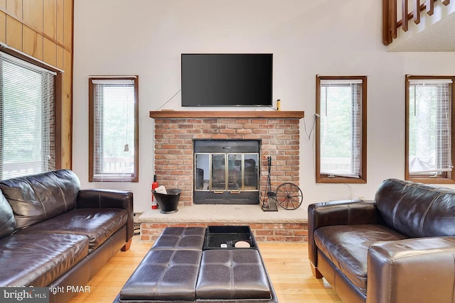 138 Banbury Dr, Bushkill, PA 18324 - living area with a brick fireplace, wood finished floors, and healthy amount of natural light