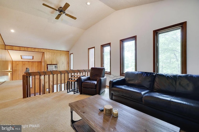 138 Banbury Dr, Bushkill, PA 18324 - living room with vaulted ceiling, wooden walls, carpet flooring, a ceiling fan, and a wall mounted AC