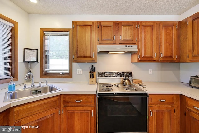 138 Banbury Dr, Bushkill, PA 18324 - kitchen with electric range, under cabinet range hood, a sink, light countertops, and a textured ceiling